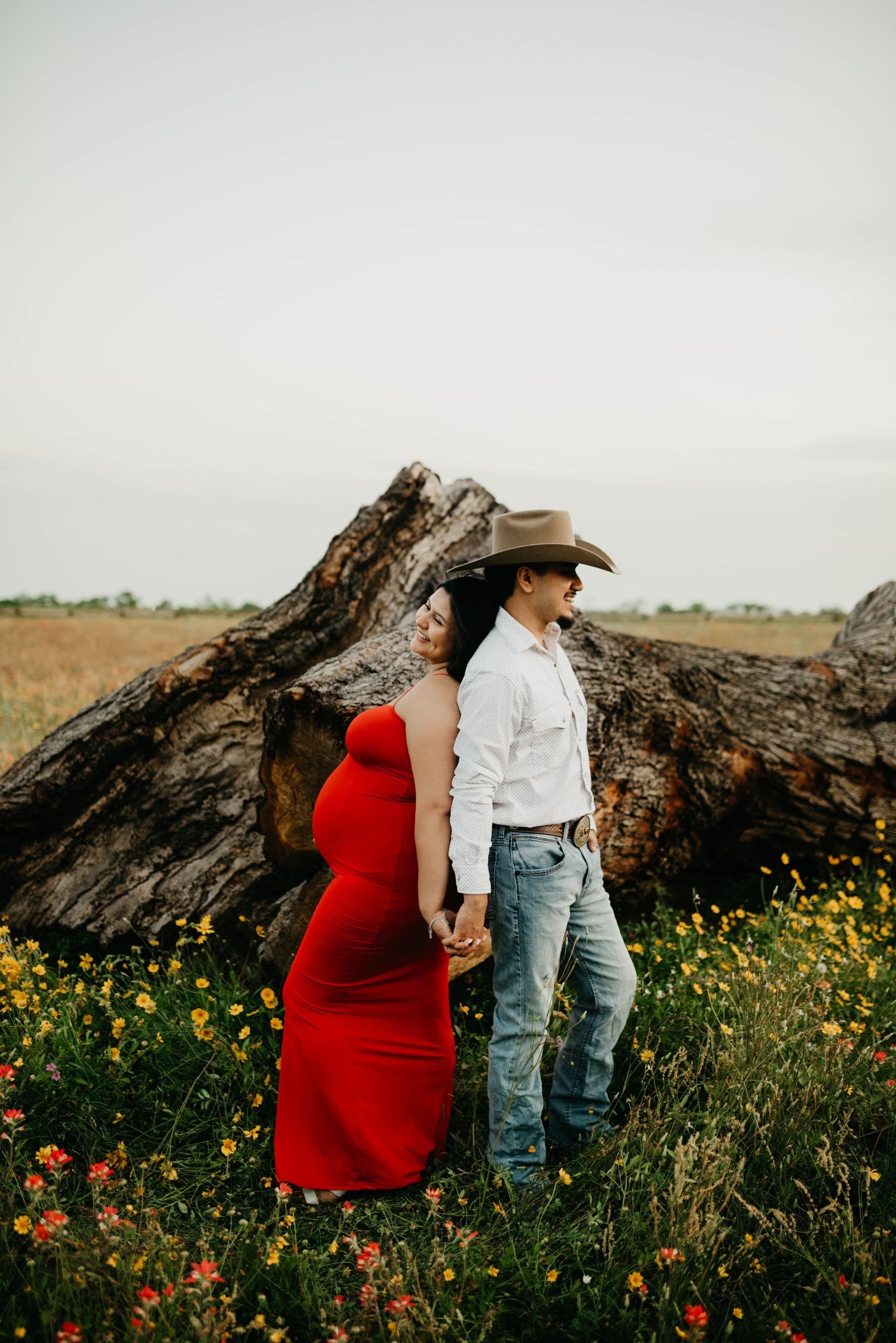 Ricky and Khia together beside a fallen tree in an open field
