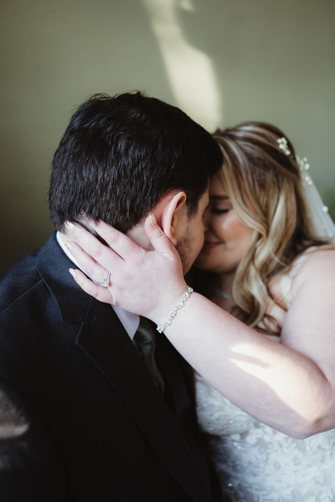 Jeff and Hannah leaning close together in soft window light